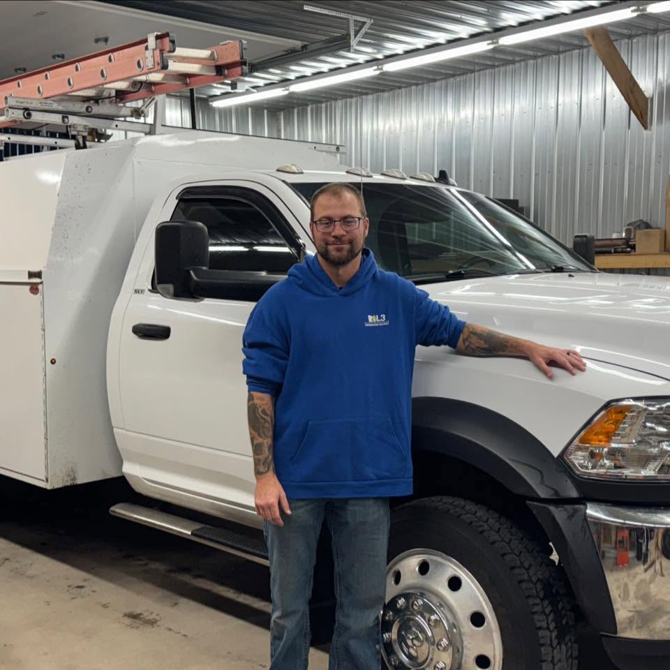 The owner of Kroening Electric LLC standing by his service truck